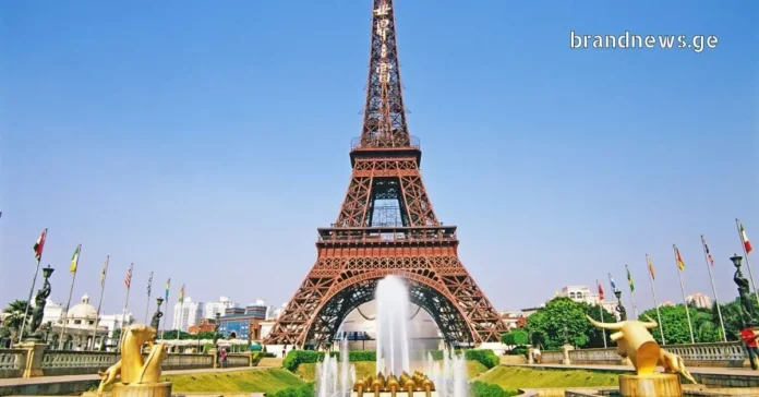 Eiffel Tower replica with golden statues and fountains at Window of the World.